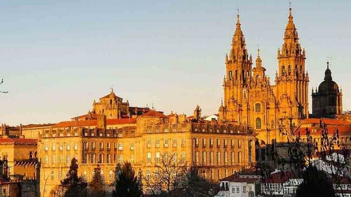 Cathedral of Santiago de Compostela with pilgrims arriving, on a private day tour from Porto