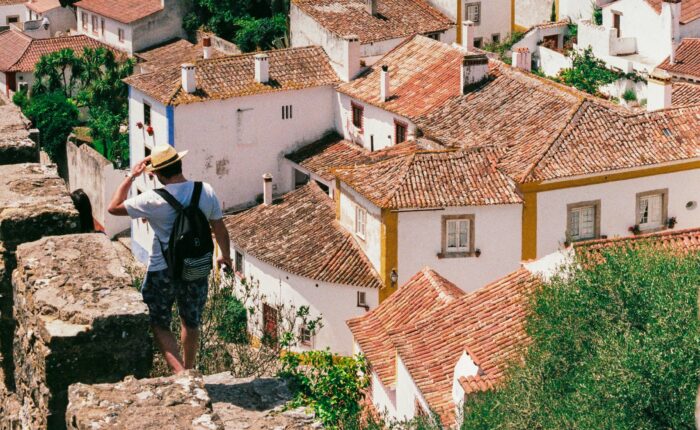 Traditional whitewashed houses with terracotta tile roofs in the medieval village of Óbidos, Portugal